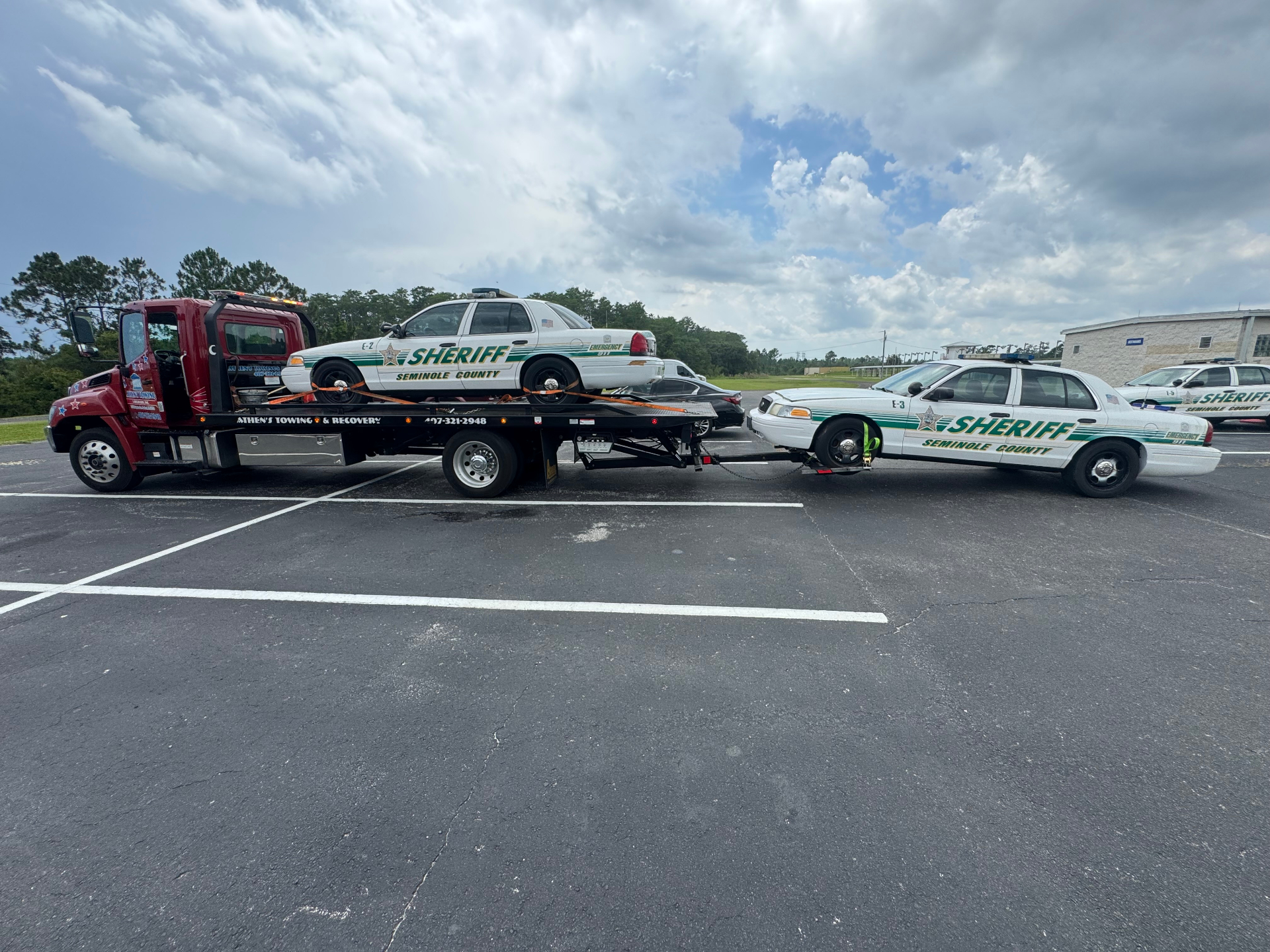 Athens Towing flatbed hauling a Seminole County Sheriff patrol car