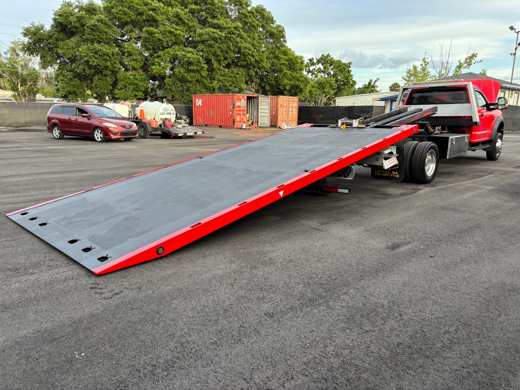 Flatbed tow truck deck extended and ready for loading