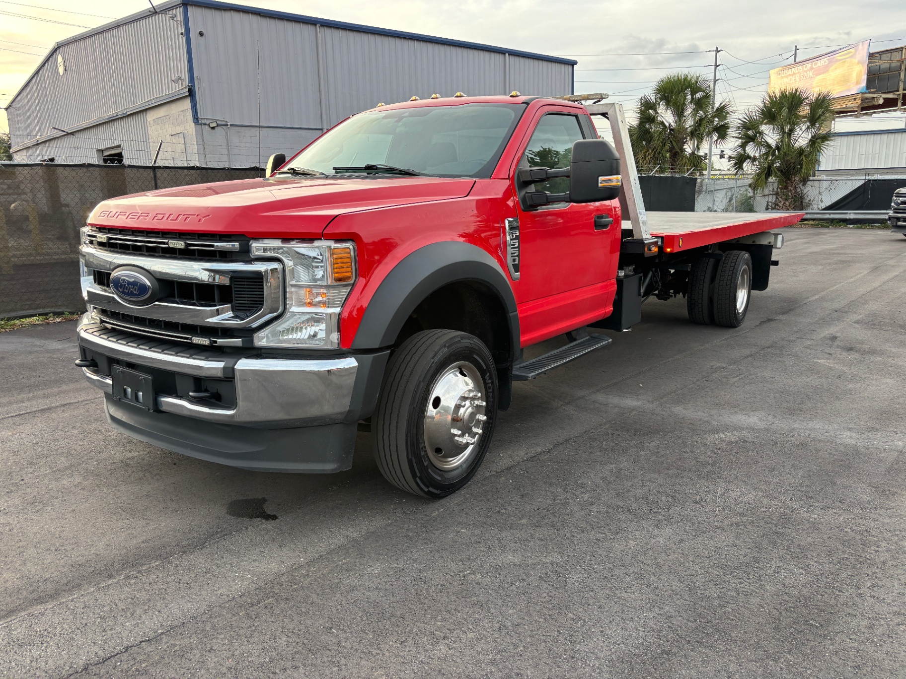 Red Ford F-550 Super Duty flatbed tow truck